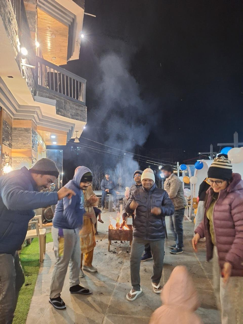 Guests dancing by the bonfire at BTH Hotels & Resorts