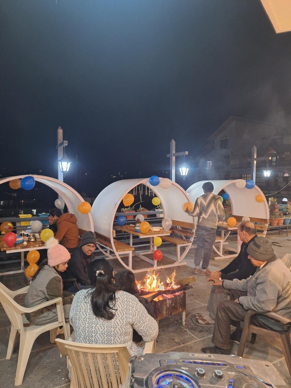 An evening bonfire gathering with guests at BTH Hotels & Resorts